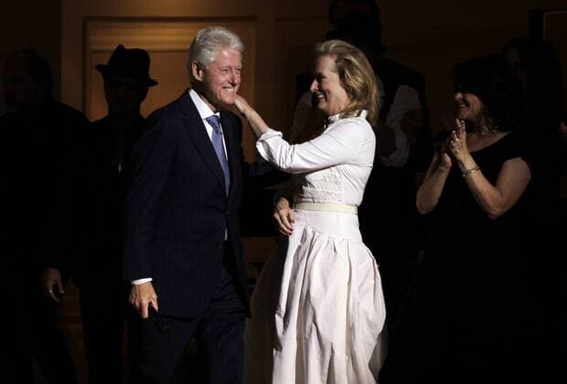 Meryl Streep reacts when former U.S. President Bill Clinton as he walks out on stage at the Revlon Concert for the Rainforest Fund at Carnegie Hall in New York City on April 3, 2012.  NYP20120403156