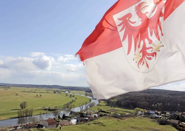 Blick auf die Fahne Brandenburgs, die Ortschaft Stolpe und den Fluss Oder bei Angermünde am 08.04.2012. Deutschland Germany Brandenburg Uckermark Landschaft Totale Uebersicht Sehenswuerdigkeit Touristen Tourismus Reisen Reise Ausflug Ausflugsziel Familienausflug Oder Oderland Fluss deutsch-polnische Grenze Flusslandschaft, Natur Naturschutzgebiet Naturpark an der Oder Flussaue Flussauenlandschaft Nationalpark Landschaftsschutzgebiet Landschaftsschutzgebiete Oderwasser Hochwasser Überflutungsgebiet Überflutungsgebiete Odertal Tal Flora Fauna Fläche Überflutungsfläche Fahne Flagge brandenburgische Brandenburger Land Reform Gebietsreform Kreisreform Eingemeindung Bundesland Kommunal Kommunalpolitik Politik Gemeindereform
