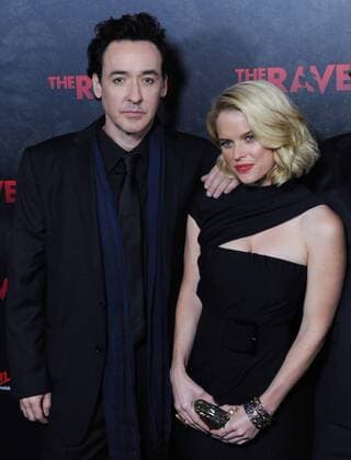 Actor John Cusack (L) and Alice Eve, cast members in the motion picture mystery thriller The Raven , attend the premiere of the film at the Los Angeles Theatre in the downtown section of Los Angeles on April 23, 2012.  LAP2012042308