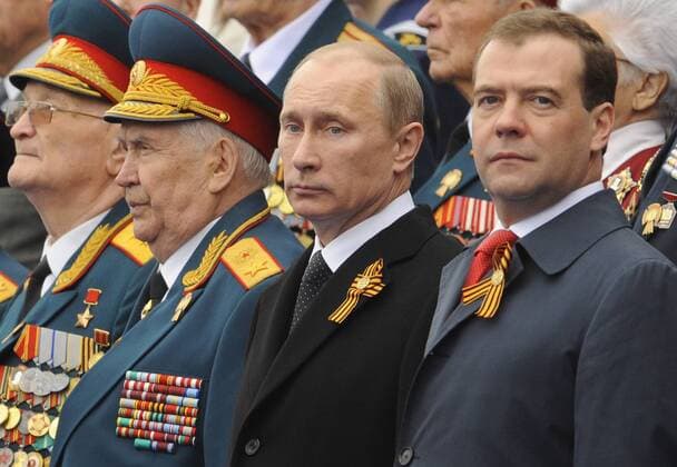 Russian President Vladimir Putin (C) and Prime Minister Dmitry Medvedev (R)attend the Victory Day parade to on the Red Square in Moscow, on May 9, 2012. Today Russia celebrates the 67th anniversary of victory over Nazi Germany.  MOW2012050906