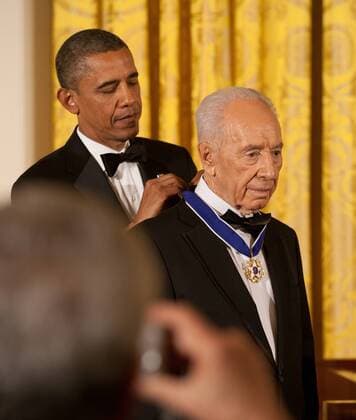 President Barack Obama awards the Presidential Medal of Freedom to Israeli President Shimon Peres during a dinner in his honor in the East Room of the White House, in Washington, DC on June 13, 2012.  WAX20120613213