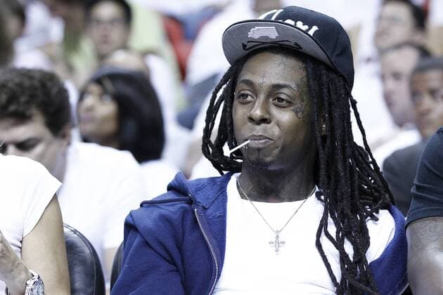 19 June 2012: American rapper Dwayne Michael Carter, Jr., better known by his stage name Lil Wayne, is seen court side during the first quarter of Game 4 of the 2012 NBA Finals, Thunder at Heat, at the AmericanAirlinesArena, Miami, Florida, USA. EDITORIAL USE ONLY 141851