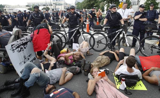 Protesters stage a sitdown after their unauthorized march was stopped by police during the 2012 Democratic National Convention in Charlotte, North Carolina on September 4, 2012.  DNC2012090424