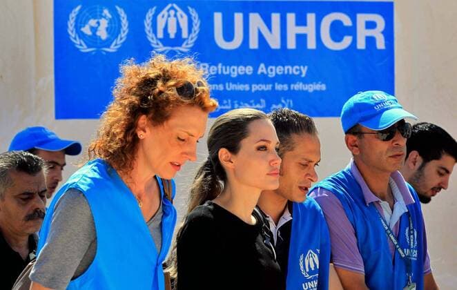 (120911) -- MAFRAQ, Sept. 11, 2012 (Xinhua) -- Actress Angelina Jolie (C), UN refugee agency s special envoy, arrives at Al Zaatri refugee camp in the Jordanian city of Mafraq, near the border with Syria, Sept. 11, 2012. The refugee camp is hosting Syrian refugees displaced by the conflict. (Xinhua Mohammad Abu Ghosh) (zyw) JORDAN-MAFRAQ-ANGELINA JOLIE-VISIT 