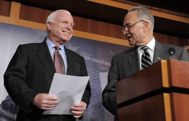 Sen. Charles Schumer (D-NY), (R) smiles at Sen. John McCain (R-AZ) as he makes remarks on a bi-partison plan to introduce immigration reform, at the US Capitol, January 28, 2013, in Washington, DC. The legislation follows the so-called Dream Act , a comprehensive path to citizenship for millions of illegal aliens in the US.  WAP20130128502