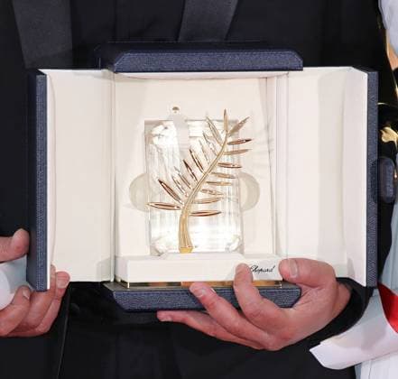 The Palm d Or statuette is seen in the hands of director Abdellatif Kechiche at the award photocall after he received the prize for the film La vie d Adele (Blue is the Warmest Colour during the 66th annual Cannes International Film Festival in Cannes, France on May 26, 2013.  CAN20130526776