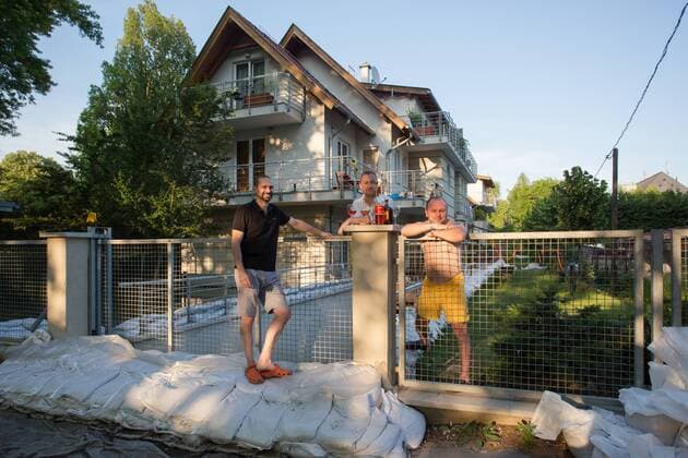 BUDAPEST, June 09, 2013 - Locals drink wine in front of their houses surrounded by sandbags to protect it from floodwaters in a suburb of Budapest, capital of Hungary, June 9, 2013. The water level of the Danube river stood at 8.91 meters in Budapest Sunday night, 0.31 meters more than the record high in 2006.(Xinhua Attila Volgyi) (yc) HUNGARY-BUDAPEST-DANUBE LEVEL-RECORD HIGH 