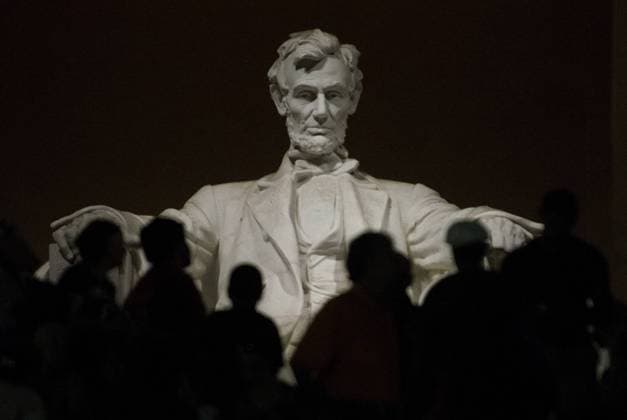A statue of President Abraham Lincoln dominates the interior of the Lincoln Memorial for tourists visiting at moonrise and sunset on the National Mall in Washington, DC on June 22, 2013. The biggest full moon of the year added to the National Mall attractions on a calm warm night in the nation s capital. The neoclassic monument is dedication to the 16th President of the United States.  WAS20130623129