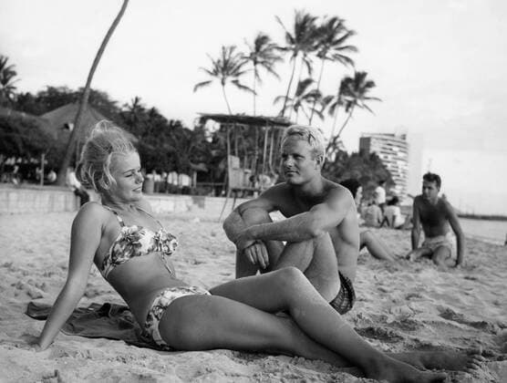 A woman sunbathing at the seaside with her boyfriend , USA UnitedArchives00128904 