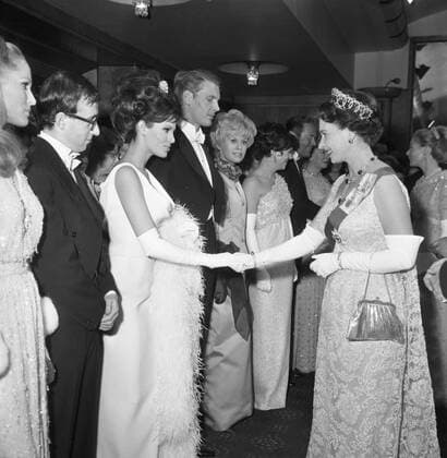 Queen Elizabeth II shaking hands with Raquel Welch before the start of the Royal film performance of Born Free at the Odeon , Leciester Square , London. On the extreme left is Ursula Andress with Woody Allen on her right. On Miss Welch s right is James Fox , Susannah leigh , Rachel Roberts and her husband Rex Harrison . 14th March 1966 UnitedArchives00153676 
