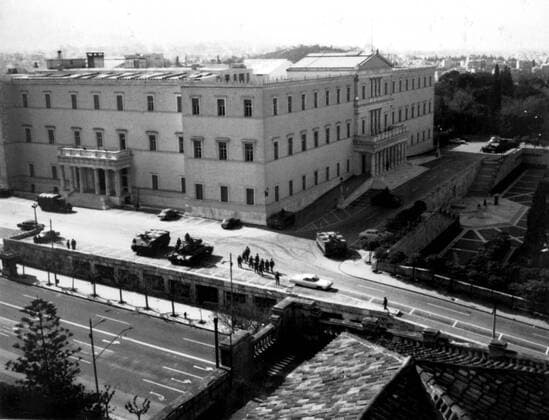 Half tracked troop carriers, tanks and Army trucks, surround Greece s parliament building, as the Greek army takes over control of the country. In the foreground troops march off to take up positions at Constitution Square. Athens - 22nd April 1967 , Athen UnitedArchives00278503 