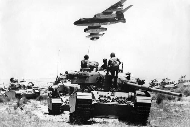 Middle East tension grows . An Israeli air force French - built Vautour bomber flying over British - made Centurion tanks in Southern Negev , Israel . 24th May 1967 UnitedArchives00418148 
