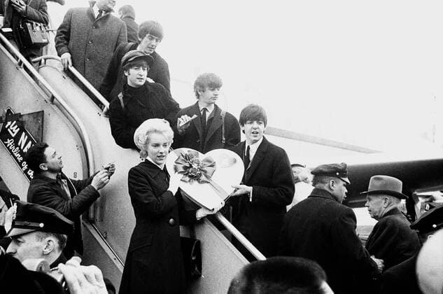 Airline hostess , Carol Callagher , presents this giant valentine box of chocolates to the Beatles as they leave New York for Miami 14th February 1964 UnitedArchives00419738 