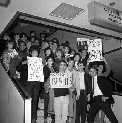 The Beatles - Fans pack a stairway at New York s JFK Airport to greet the Beatles , Paul McCartney , Ringo Starr , John Lennon and George Harrison . 7th February 1964 UnitedArchives00419797 