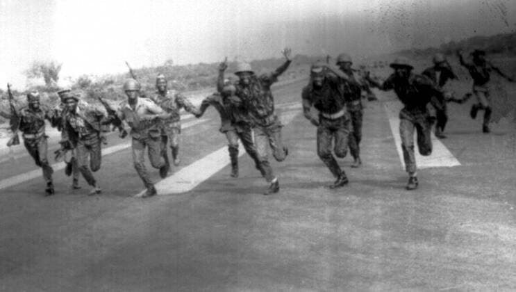 Federal Nigerian troops run wildly about the Uli Airport after hearing Lt General Phillip Effiong, commander of the Biafran forces, make his surrender broadcast from a mobile radio truck at Uga near the airport and today, Biafra s five men peace delegation began talks with Nigerian leader General Yakubo Gowon on terms of a final amistice in the Nigerian civil war. 15th January 1970. UnitedArchives00475640 