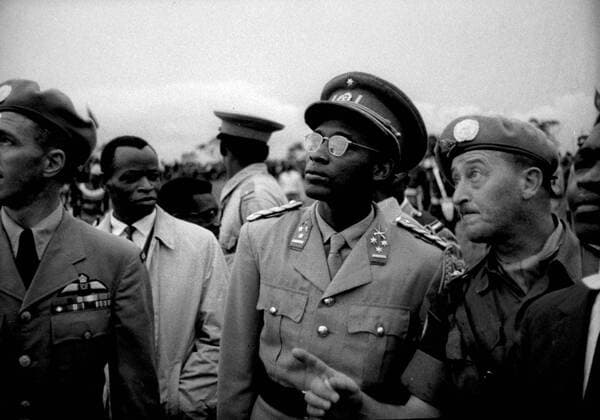 Colonel Joseph Mobutu Chief of the Congolese army with UN officers watching paratroopers of the Congo army making their first jump from an aircraft. 30 troops who have been trained by the United Nations took part. Leopoldville - 21st November 1960, Vereinte Nationen, UN UnitedArchives00498164 