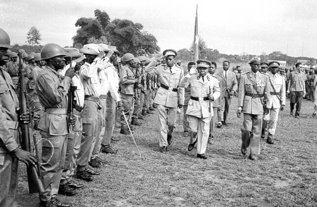 Congo President, Joseph Kasavubu (2nd right) reviews troops accompanied by former Colonel newly appointed Major-General Joseph Mobutu (centre) during a parade to celebrate his new rank at Leopoldville s Kokolo military camp. Extreme right is Major M. Kilembe who succeeds Mobutu as Chief of Staff. Leopoldville - 23rd January 1961 UnitedArchives00498171 