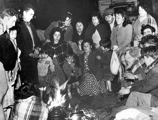 Earthquake in Chile. A group of people made homeless by the earthquakes sit round a fire. Many thousands of homeless are having to seek temporary accommodation outside the cities and towns May 1960 UnitedArchives00514940 