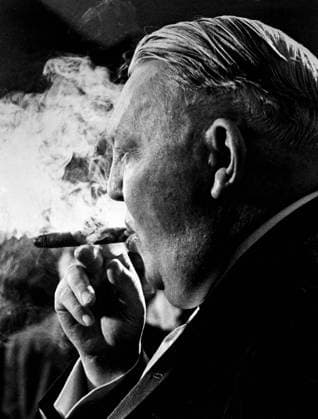 West German Vice Chancellor Ludwig Erhard seems to be putting up a smoke screen from his cigar as he talks to newsmen following a 90 minute conference with President Kennedy at the White House. Erhard said that he and the president had a general discussion of world problems. He told the reporters that a proposal by the Soviet Union for Bilateral talks on the Berlin Germany problem was a propoganda move with little political reality 10th January 1962, Zigarre, rauchen, Raucher, Deutschland, Kanzler, Reichskanzler, Bundeskanzler UnitedArchives00514953 