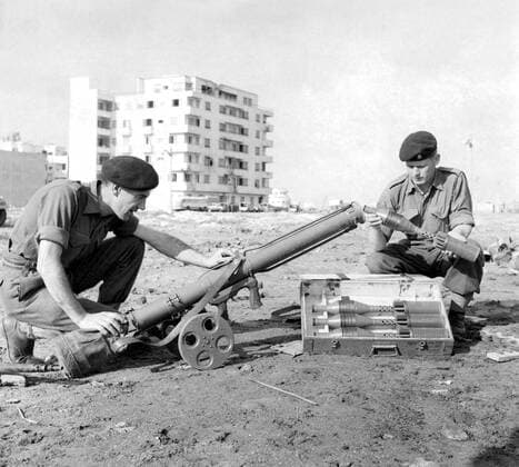 British Troops, Private Kenneth Yoxall, from Crewem and Corporal Peter Absalom (right) from Bridgend, South Wales, examine a captured Russian rocket-launcher used by the Egyptian infantry during the fighting in Port Said. Suez Crisis - 13th November 1956 UnitedArchives00549939 