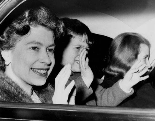 HM The Queen Elizabeth II with two of her children Prince Andrew and Princess Anne leaving Buckingham Palace by car 23rd December 1965 UnitedArchives00549953 