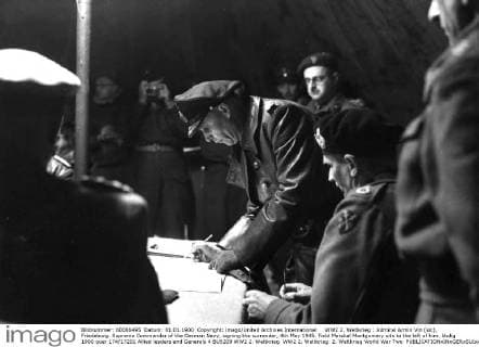 WW2: Admiral Armin Vin (sic), Friedeburg. Supreme Commander of the German Navy, signing the surrender, 4th May 1945. Field Marshal Montgomery sits to the left of him. UnitedArchives00922195 