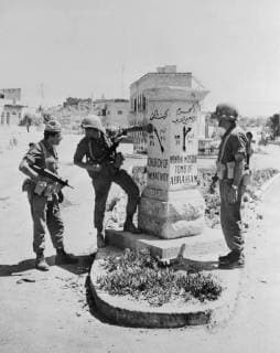 6 Day War Bethlehem, Jordon: Israel troops pause at a pillared signpost at the entrance to Bethlehem, after Israeli forces had occupied the birthplace of the Prince of Peace. The battle for the birthplace of Jesus took place Wednesday night. It was short and deadly as Israeli gunners went in behind tanks. Some 30 to 40 Jordanians manning strongpoints were reported killed. Others fled in the moonless night. With three main Arab combatants having accepted the security council demand for a cease-fire, the Arab-Israeli war appeared to be flickering out. 8 June 1967 UnitedArchives00928659 