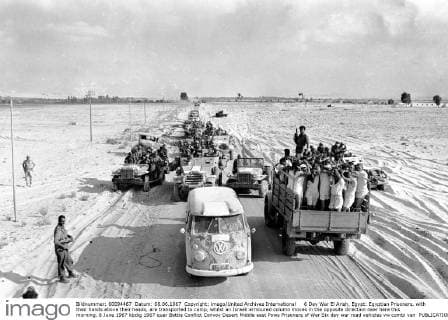 6 Day War El Arish, Egypt: Egyptian Prisoners, with their hands above their heads, are transported to camp, whilst an Israeli armoured column moves in the opposite direction near here this morning. 8 June 1967 UnitedArchives00928663 