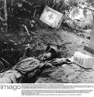 This photograph , issued by the Biafra Information service , allegedly shows a Nigerian federal soldier killed in Ikot Ekpene. At the side of the soldier is a carton of food bearing the words : Donated by the people of the United States of America. In the background is another carton containing red cross supplies . 12th July 1968  UnitedArchives00941285