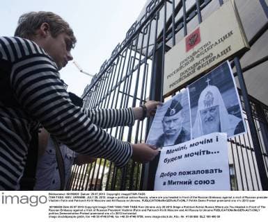ITAR-TASS: KIEV, UKRAINE. JULY 25, 2013. People stage a political action Russia, where are you headed in front of the Russian Embassy against a visit of Russian president Vladimir Putin and Patriarch Kirill of Moscow and All Russia to Ukraine.  RE1233B2