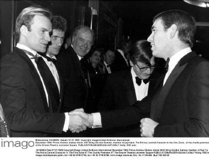 December 1984: Prince Andrew shakes hands with Sting (Gordon Sumner, member of pop band, The Police), central character in the film, Dune , at the charity premiere at the Empire Theatre, Leicester Square.  UnitedArchives00956720