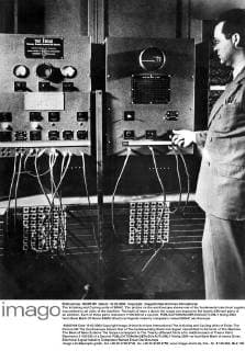 The Initiating and Cycling units of ENIAC. The picture on the oscilloscope shows one of the fundamental electrical signals transmitted to all units of the machine. The bank of neon s above the scope correspond to the twenty different parts of an addition. Each of these parts represent 1 100,000 of a second.  UnitedArchives01008683
