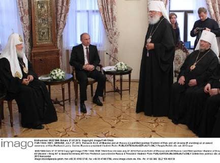 ITAR-TASS: KIEV, UKRAINE. JULY 27, 2013. Patriarch Kirill of Moscow and all Russia (L) and Metropolitan Vladimir of Kiev and all Ukraine (R standing) at an award ceremony at Kiev Pechersk Lavra. Centre: Russia s president Vladimir Putin.  RE123748