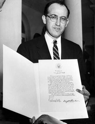 Washington ; The world s thanks for his achievments are expressed in the citation Dr Jonas Salk holds . Presented by President Eisenhower , the tribute praises Dr Salk s signal and historic contributions to all human welfare in the development of his polio vaccine . 25th April 1955  UnitedArchives01160364