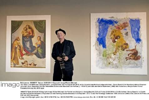 Der Maler und Bildhauer Georg Baselitz, aufgenommen am Freitag (20.09.2013) in der Ausstellung Hintergrundgeschichten - Georg Baselitz im Residenzschloss Dresden zwischen einer Reproduktion des Gemaeldes Sixtinische Madonna von Raffael (I - 1512 13) und dem Gemaelde Statement (1999) des Kuenstlers. RM001