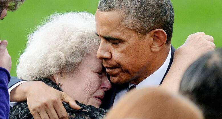 President Barack Obama comforts families of the victims at a memorial for the victims of the Washington Navy Yard shooting at the Marine Barracks, September 22, 2013 in Washington, D.C. Twelve people were killed at the Navy Yard by a naval contractor on Monday, September 16, 2013.  WAX20130922167