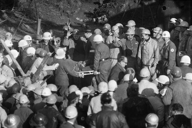 Vor 50 Jahren, am 24. Oktober 1963, wurden in einem Stollen der Eisenerzgrube Lengede-Broistedt bei Peine 129 Bergleute in 60 m Tiefe verschüttet. Die Rettung von 11 eingeschlossenen Bergleuten nach 14 Tagen ging als Wunder von Lengede in die Geschichte ein, Einer der am 7. November geborgenen Bergleute wird auf einer Trage von Sanitätern, Rettungskräfte n, weggebracht, er trägt eine Sonnenbrille gegen das grelle Licht, beobachtet und bejubelt von Bergleuten, Grubenunglück und Wunder von Lengede im Oktober November 1963, SW-Aufnahme, 07.11.1963. Grubenunglück von Lengede, Alter Mann, Schacht Mathilde, Wunder von Lengede, Bergmann, Kumpel, Bergleute, Wassereinbruch, Grube, Erzbergwerk, Bergwerk, Unter Tage, Rettung, Dahlbuschbombe, Rettungsbohrung, Eisenerzgrube Lengede-Broistedt, Katastrophe, Bohrloch, Verschüttete, Rettungskapsel, Steiger, Klärteich, Überlebende, Bergbau