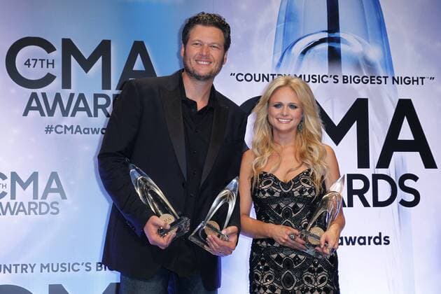 Blake Shelton, winner of Male Vocalist of the Year, and his wife Miranda Lambert, winner of Female Vocalist of the Year, poses backstage during the 47th Annual Country Music Awards at Bridgestone Arena in Nashville on November 6, 2013.  CMA20131106312