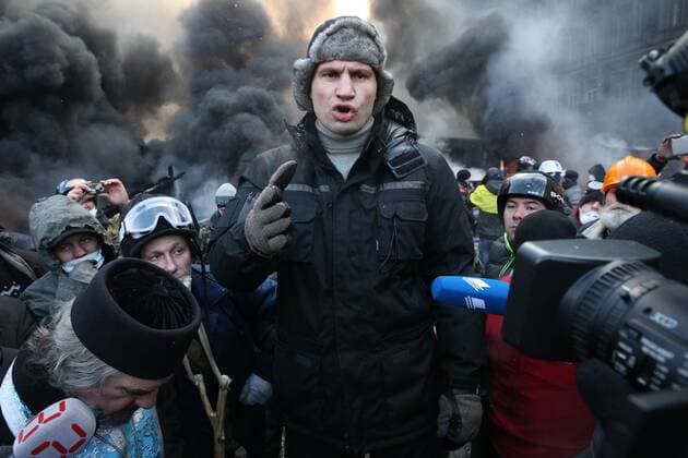 ITAR-TASS: KIEV, UKRAINE. JANUARY 23, 2014. Udar party leader Vitali Klitschko (L) is among opposition demonstrators who rally in Kiev s Grushevsky Street. On 16 January 2014 Ukraine s parliament, Verkhovna Rada, adopted tougher security laws, which sparked a new wave of violence in the capital.  RE136B80