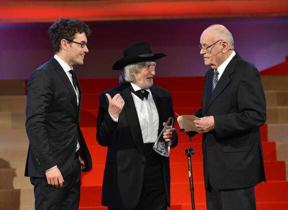 Stepan Hulik (left), screenwriter of the Burning Bush (Horici Ker) movie recieves the annual award Czech Lion for the best director for Agnieszka Holland from directors Juraj Jakubisko (middle) and Vaclav Vorlicek in Prague, Czech Republic on February 22, 2014. Burning Bush is a 2013 three-part mini-series created for HBO by Polish director Agnieszka Holland. (CTKxPhoto MichalxDolezal) CTKPhotoP201402220847501  DOL_9895