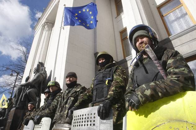 Ukrainian self defense volunteers stand outside the parliament building in Kiev on March 17, 2014 a after the referendum on independence in Crimea.  KIE2014031727
