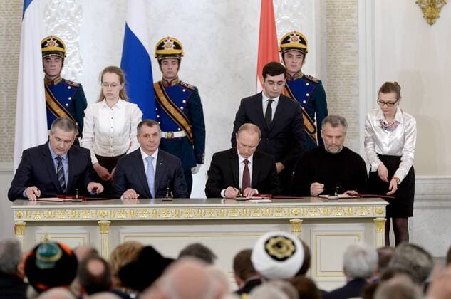 ITAR-TASS: MOSCOW, RUSSIA. MARCH 18, 2014. Crimean Prime Minister Sergei Aksenov, Crimean Supreme Council chairman Vladimir Konstantinov, Russian president Vladimir Putin, and Sevastopol head Alexei Chalyi (L-R sitting) sign an interstate unification agreement between the Russian Federation, the Republic of Crimea and the city of Sevastopol. Under the terms of the agreement, the Republic of Crimea and Sevastopol become federal subjects of the Russian Federation.  RE13D2A0
