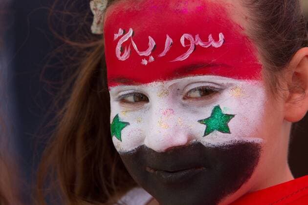 A girl of the Druze community attends a rally marking Syria s Independence Day in the Druze village of Majdal Shams on the Golan Heights, on April 17, 2014. Hundreds of members of the Druze community took part in the rally on Thursday to mark Syria s independence day. Israel captured the Golan Heights in a 1967 war and then annexed the strategic territory overlooking northern Israel in 1981. (Xinhua JINI) MIDEAST-GOLAN HEIGHTS-DRUZE VILLAGE-MAJDAL SHAMS-SYRIA-INDEPENDENCE DAY 
