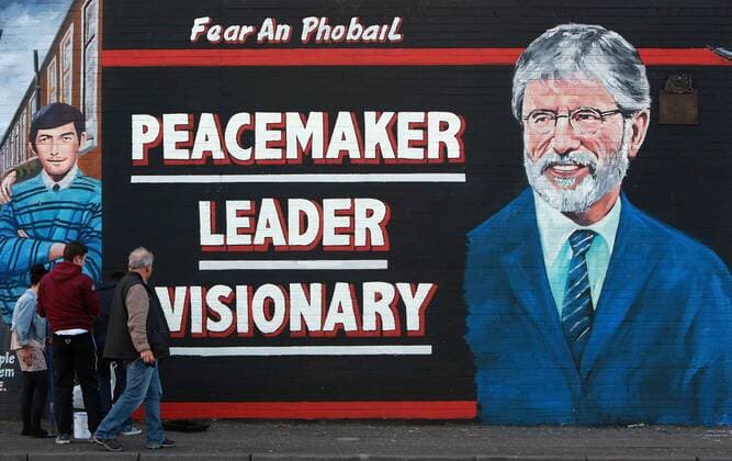 Young boys pose in front of a new mural of Gerry Adams which appeared on the Falls Road, west Belfast, Northern Ireland, on Friday, 2nd May 2014.  IIM-2176-0006