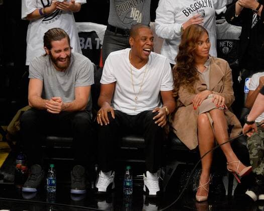 Actor Jake Gyllenhaal, Rapper Jay Z and Beyonce share a laugh in the fourth quarter in Game 3 of the Eastern Conference Semifinals at Barclays Center in New York City on May 10, 2014. The Nets defeated the Heat 104-90 for a 2-1 Miami Heat series lead.  NYP20140510125
