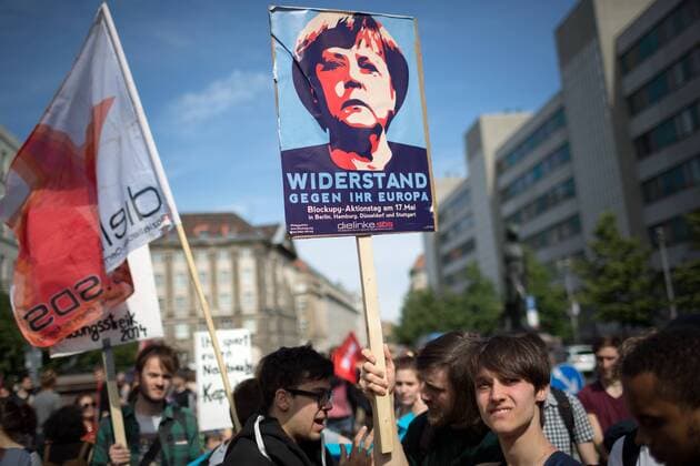 Mehrere tausend Menschen beteiligen sich am Blockupy-Aktionstag mit Protesten in mehrere Städten an einer Demonstration in Berlin. Die Demonstranten protestieren gegen den Finanzkapitalismus und die europaeische Sparpolitik zur Eindämmung der Eurokrise, gegen steigende Mieten und zeigen ihre Solidarität mit der Flüchtlingsprotestbewegung. Demonstrant mit Plakat mit dem Konterfei von Angela Merkel und dem Spruch: Widerstand gegen ihr Europa. Blockupy Berlin