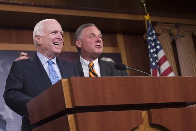 Sen. John McCain (R-AZ) and Sen. Richard Burr (R-NC) joke together during a press conference on the proposed Veterans Affairs bill, on Capitol Hill in Washington, D.C. on June 3, 2014.  WAP20140603356