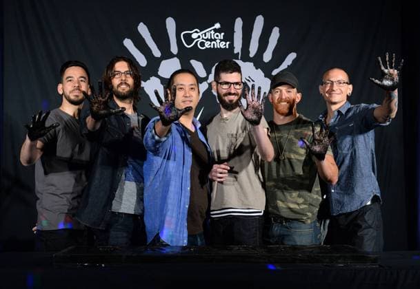 Members of the American rock band Linkin Park, Mike Shinoda, Rob Bourdan, Joe Hahn, Brad Delson, Dave Farrell and Chester Bennington (L-R), participate in a ceremony inducting the group into Guitar Center s RockWalk in the Hollywood section of Los Angeles on June 18, 2014.  LAP2014061806