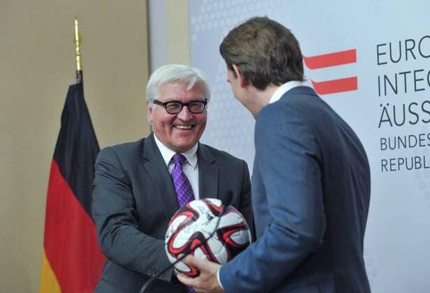 VIENNA, June 19, 2014 (Xinhua) -- Austrian Foreign Minister Sebastian Kurz (R) receives a football as a gift from his German counterpart Frank-Walter Steinmeier during a press conference after their meeting in Vienna, Austria, June 19, 2014. (Xinhua Qian Yi) (zjy) AUSTRIA-VIENNA-GERMANY-FM-MEETING 