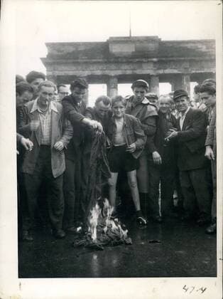 Jun. 17, 1953 - East Berlin workers are pictured here burning a flag of the communist colors at Brandenburg Gate.  - ZUMAk09